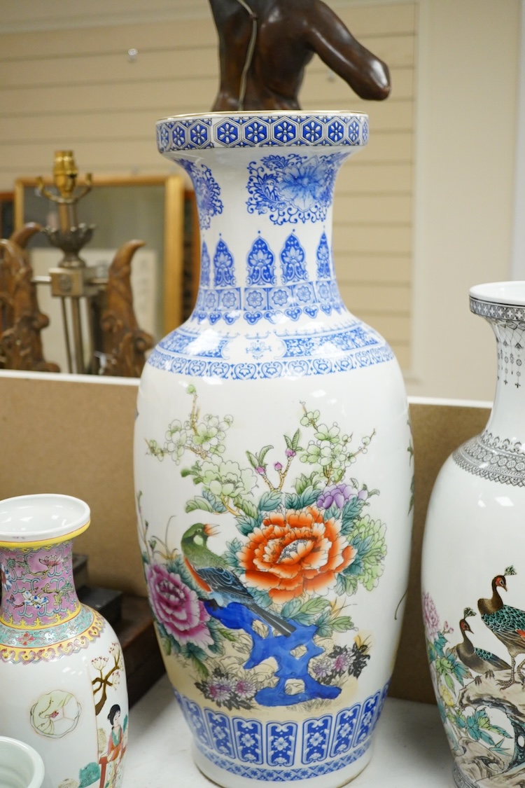 A large pair of Chinese polychrome vases, 60cm high, a pair of famille rose vases, a blue and white brushpot and two other vases (7).
